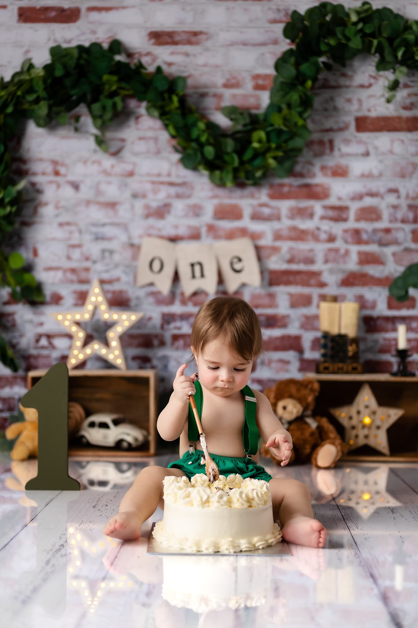 Baby boy playing with cake in studio