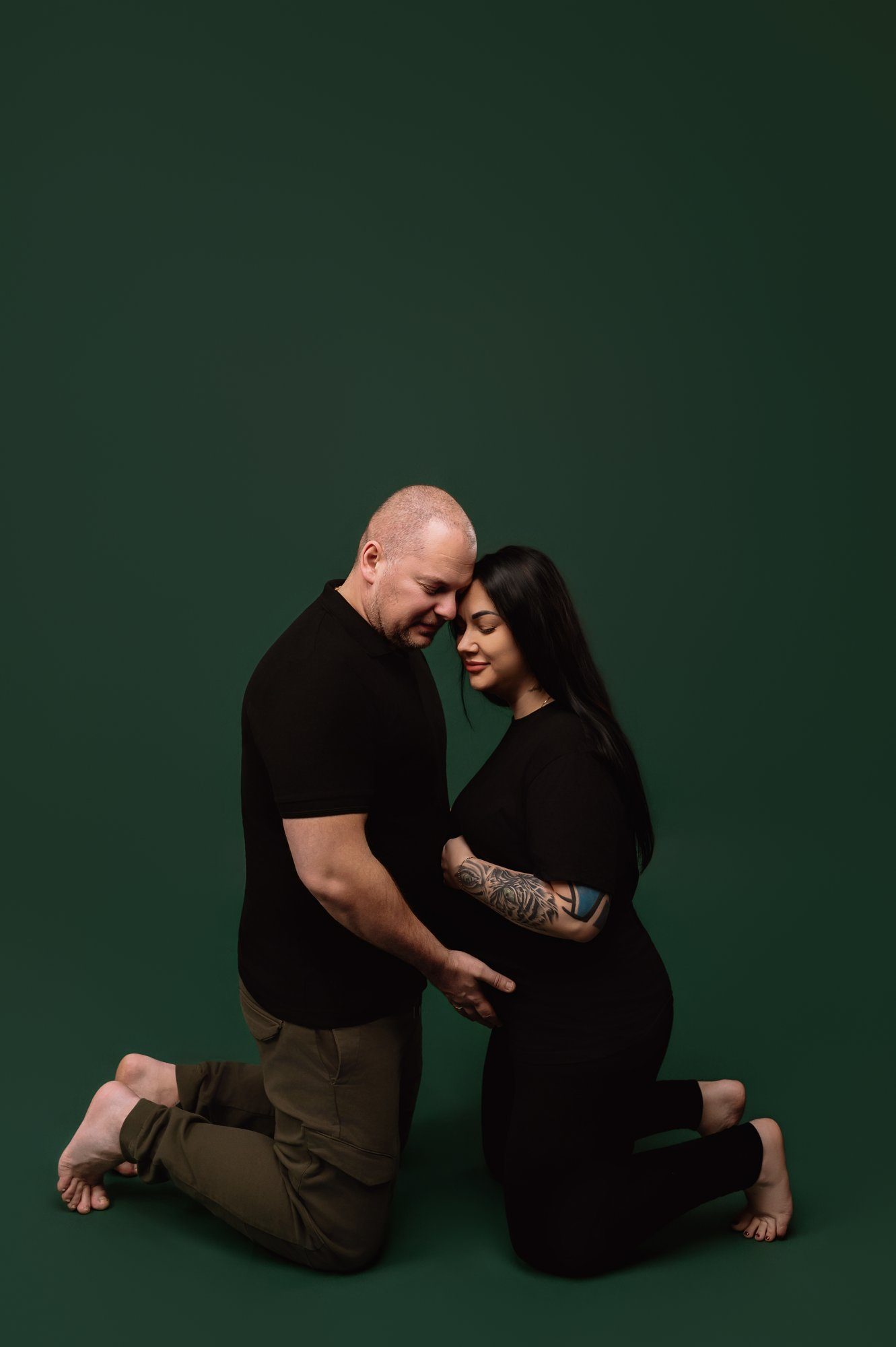 Couple embracing during intimate maternity photography session in Milton Keynes