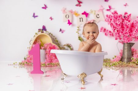 Toddler smiling during cake smash session