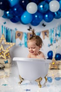 Baby laughing while playing in bath