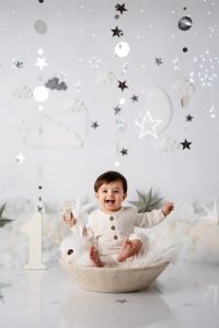 Baby boy smiling during cake smash photography