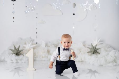 Toddler laughing at birthday cake