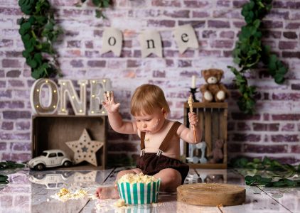 Baby laughing with frosting on face