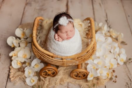 Sleeping newborn baby on cream textured blanket