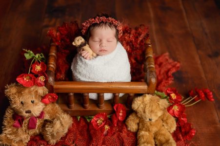 Adorable newborn baby girl in floral backdrop