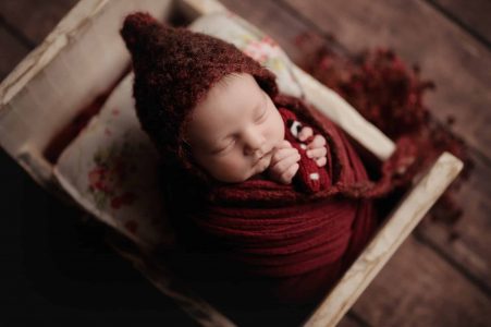 Newborn baby curled up sleeping peacefully
