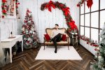 Man seated on a cream sofa in the Elegance Christmas set