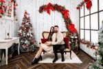 Couple seated on a cream sofa in the Elegance Christmas set, Northampton studio