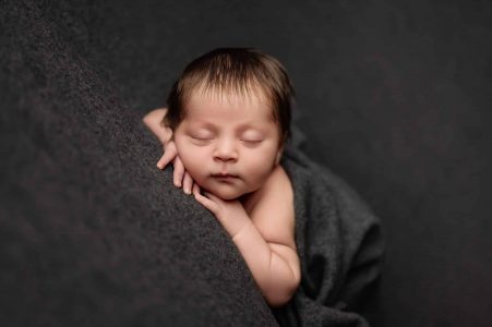 Newborn photography in MK on a posing table Newborn photography in MK on a posing table